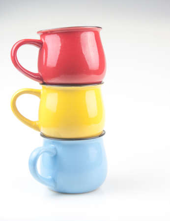 Set colorful ceramics cups on white backgroundの写真素材