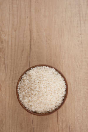 Bowl of white rice on wood table. top viewの写真素材