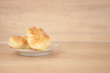 Two bun with poppy seeds on wood tableの写真素材