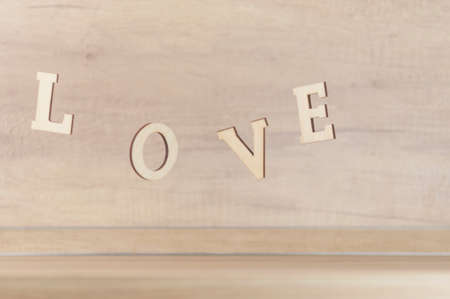 Flying in the form of word love on a wooden background. Happy valentines dayの写真素材
