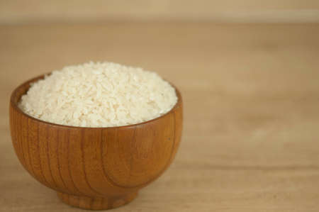Bowl of white rice on wood tableの写真素材