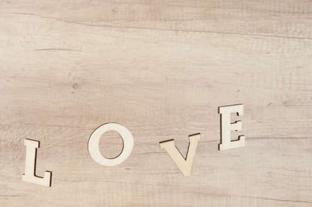 Flying in the form of word love on a wooden background. Happy valentines dayの写真素材