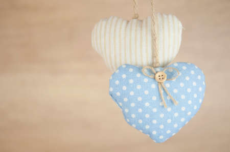 Fabric colorful hearts hanging on brown wooden wall. Happy valentines dayの写真素材