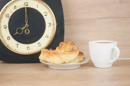 Two bun with poppy seeds with coffee cup on wood table. Breakfast. Good Morning. Coffee timeの写真素材