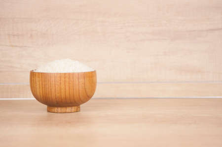 Bowl of white rice on wood tableの写真素材