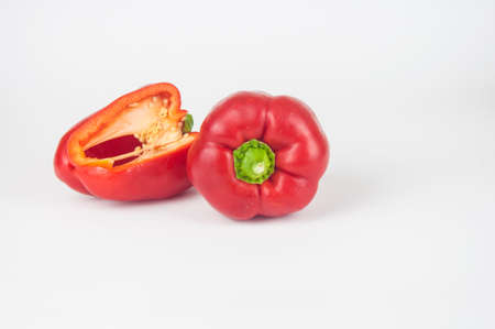 two red sweet bell peppers on white backgroundの写真素材