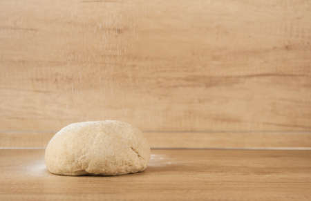 Dough for pizza and bread on a wooden tableの写真素材