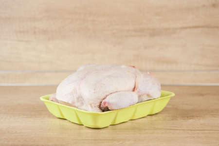 Raw frozen chicken on the tableの写真素材