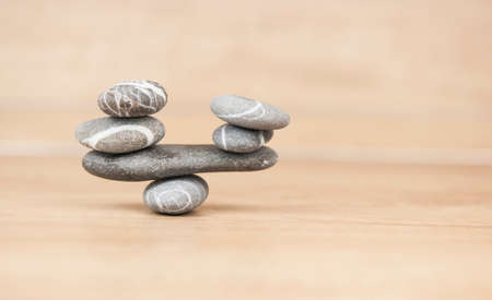 Stack of pebble stones on a wooden surface. Concept zen, spa, relax.の写真素材