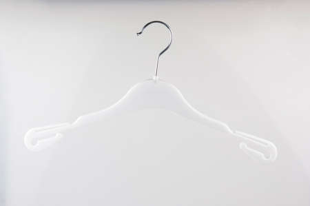Single empty cloth hanger on white backgroundの写真素材