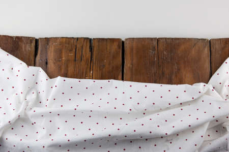 white polka dot tablecloth or towel over the surface of a brown wooden table