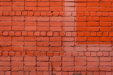 texture of bright red brick wall on sunny day.の写真素材
