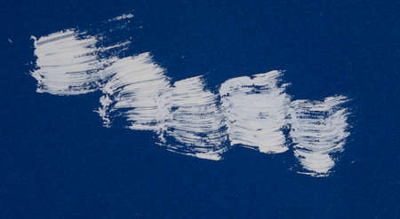Texture of white brush strokes on blue background.