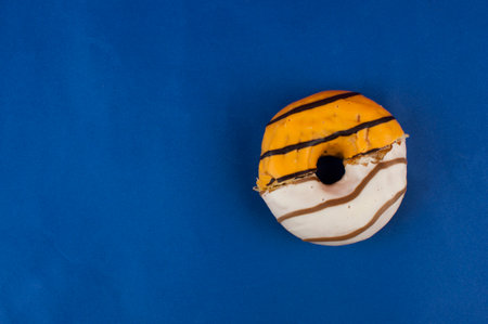 Half the donut is eaten. Two halves of the donut in one. Whole donut made up of two halves. Top viewの写真素材