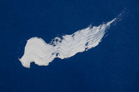 Texture of white brush strokes on blue background.