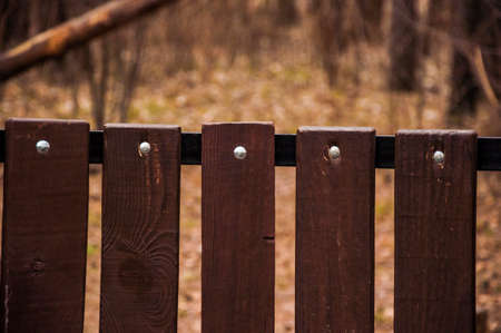 Artificial planks benches with metal rivets close-upの写真素材