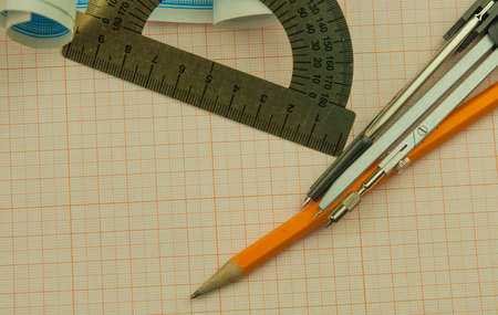 Mathematical instruments lie on a graph paper with copy space for text. Math graphic tools concept.の写真素材
