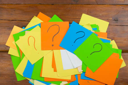 Question mark heap on table concept for confusion, question or solutionの写真素材