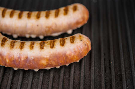 Home sausage fried on home electric grillの写真素材
