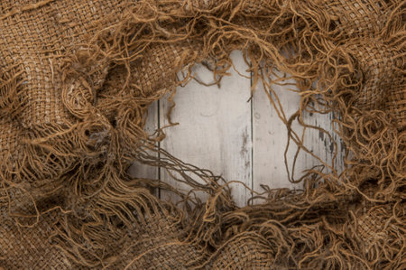 Burlap texture on white wooden table background. Wooden table with sacking. Copy spaceの写真素材