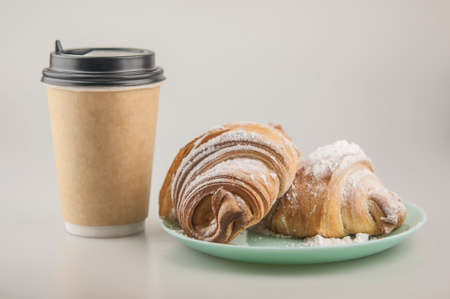 Two fresh croissants in plate on white background. Breakfastの写真素材