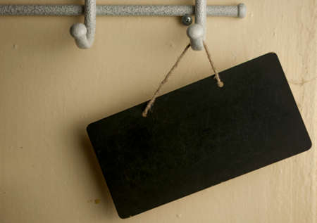 Black notice board with copy space over wooden backgroundの写真素材