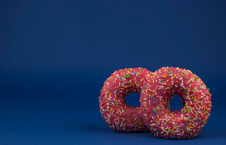 Raspberry fresh homemade donuts on a dark blue backgroundの写真素材