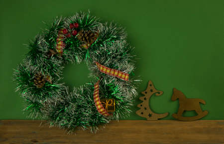 Handmade Christmas wreath on green background. Top view. Advent wreath. New year composition. Top view, flat lay. Copy space. Decoration for Christmas celebration. Greeting card, minimal concept.の写真素材