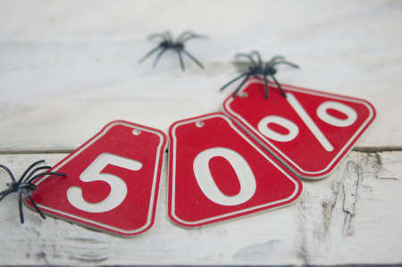 fifty percent discount on Halloween background-price tag on a rustic old white wooden backgroundの写真素材