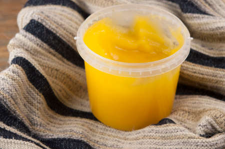 cozy autumn a jar of honey and a warm knitted sweater