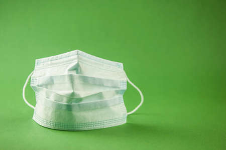 Surgical or medical mask with rubber ear straps. Procedure mask from bacteria. Protection concept.の写真素材