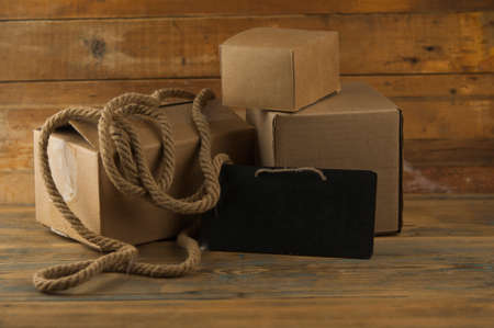 Pile cardboard boxes on a wooden background. Ð¡argo deliveryの写真素材