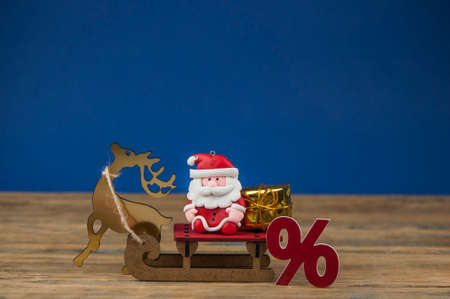 Santa Claus and sign percentege on wood background Merry Christmas. Happy new yearの写真素材