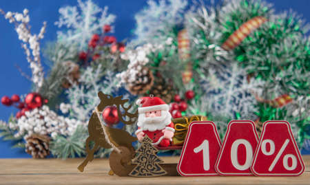 Big sales 10%, ten percents with Christmas decoration on a old barn plank background, front view, copy space. Christmas big sale.の写真素材