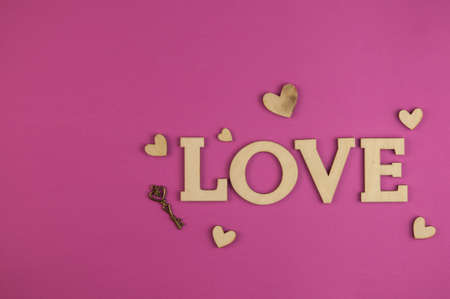 Love word, small hearts on pink pastel background. Top view of Valentine's Day. copyspace.の写真素材