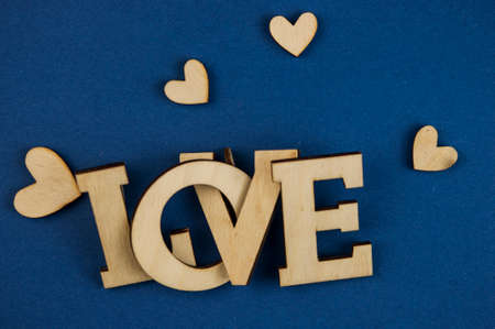 Love word, small hearts on dark blue paper background. Top view of Valentine's Day. copyspace.の写真素材
