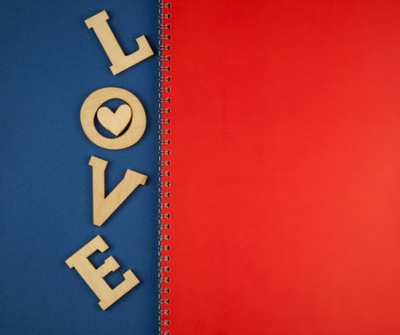 Love word, small hearts on colorful paper background. Top view of Valentine's Day. copyspace.の写真素材