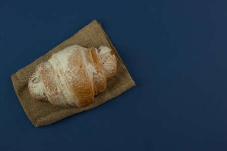 croissant on blue background fresh bakery sweet dessert bun snack healthy meal copy space for text food background rustic imageの写真素材
