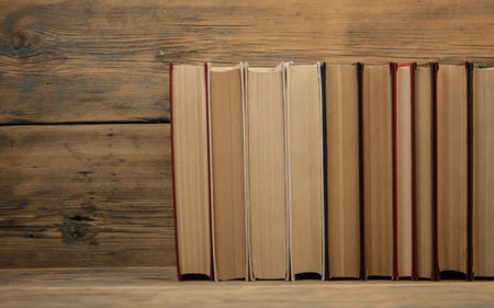 Stack books on wooden background. Back to school with copy space.の写真素材