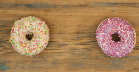 delicious and appetizing donuts on a wooden table.の写真素材