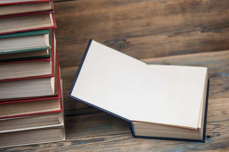 Stack books on wooden background. Back to school with copy space.