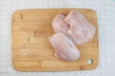 Raw chicken fillet on cutting board. top viewの写真素材