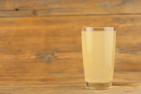 Lemonade on a glass cup on wood tableの写真素材