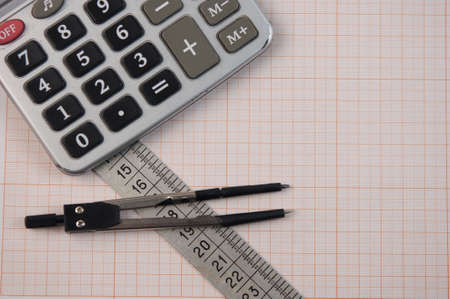 Mathematical instruments lie on a graph paper with copy space for text. Math graphic tools concept.の写真素材