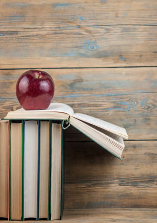 stack of books with red apple on the wood table with copy space. back to schoolの写真素材