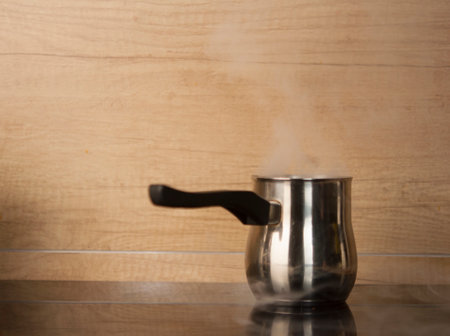 Turk for coffee is on the stove in the kitchenの写真素材