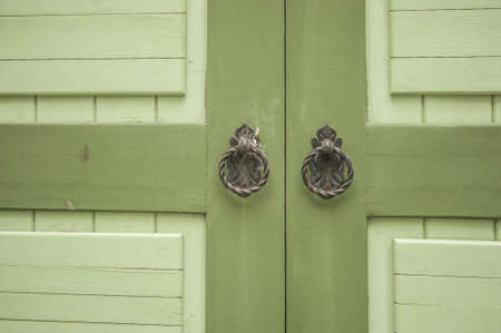 Classic vintage golden door knobs. Antique door knobs with carvings on wooden door.の写真素材
