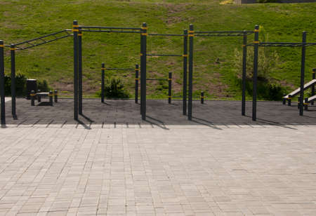 fitness sports fields with stainless steel tools resemble torture tools with chains and handles. soft rubber surface sports ground outdoor gym.の写真素材