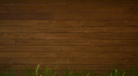 Wooden wall, background framed with green bushes and grassの写真素材