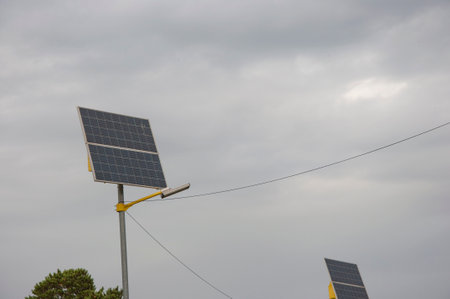 Solar panels in public park backgound. Photovoltaic modules for renewable energy, system of electric generators from the sun. Clean technologies, green and renewable energy, eco friendly electricityの写真素材